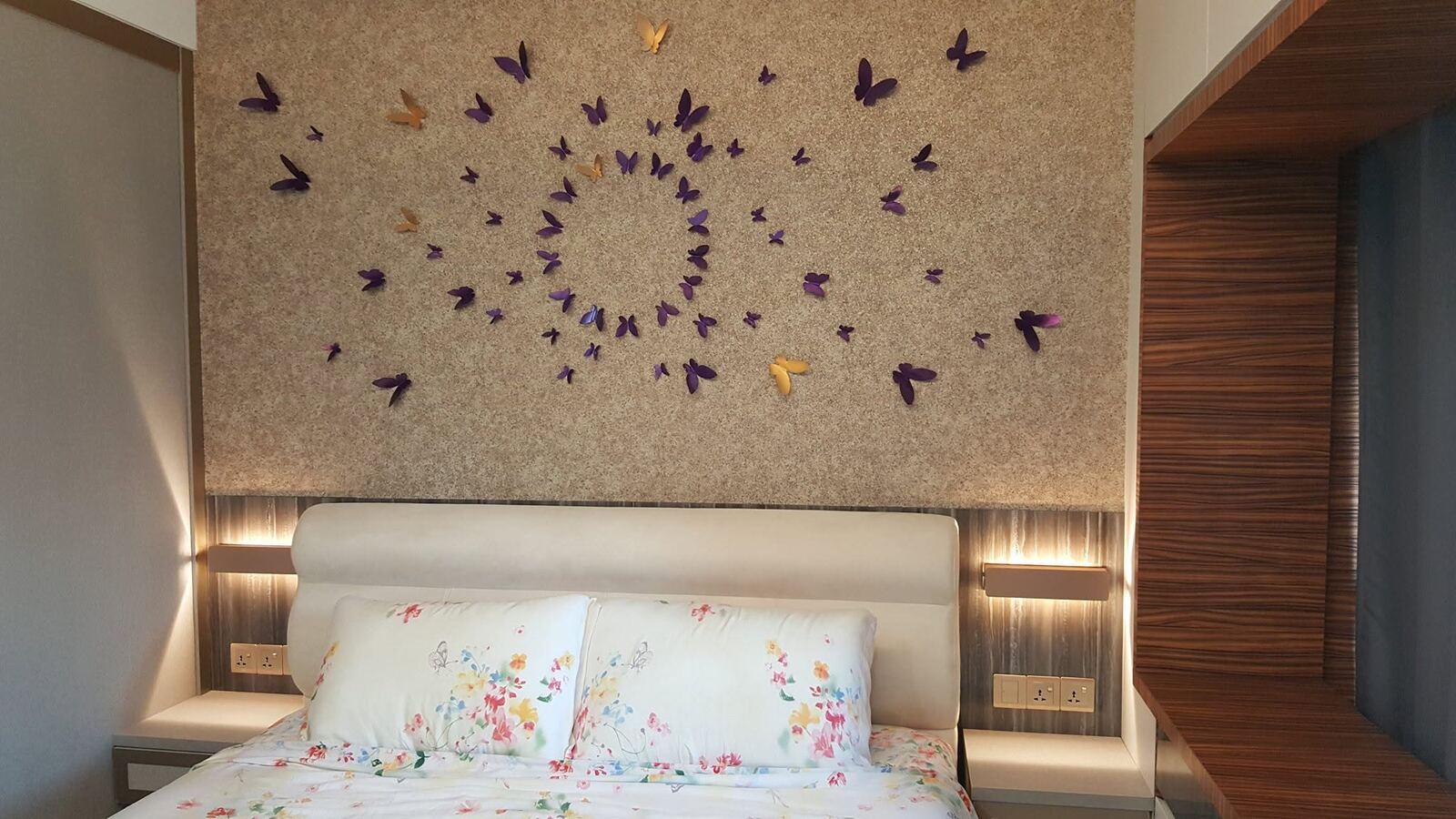 Bedroom feature wall with butterfly art and oak headboard