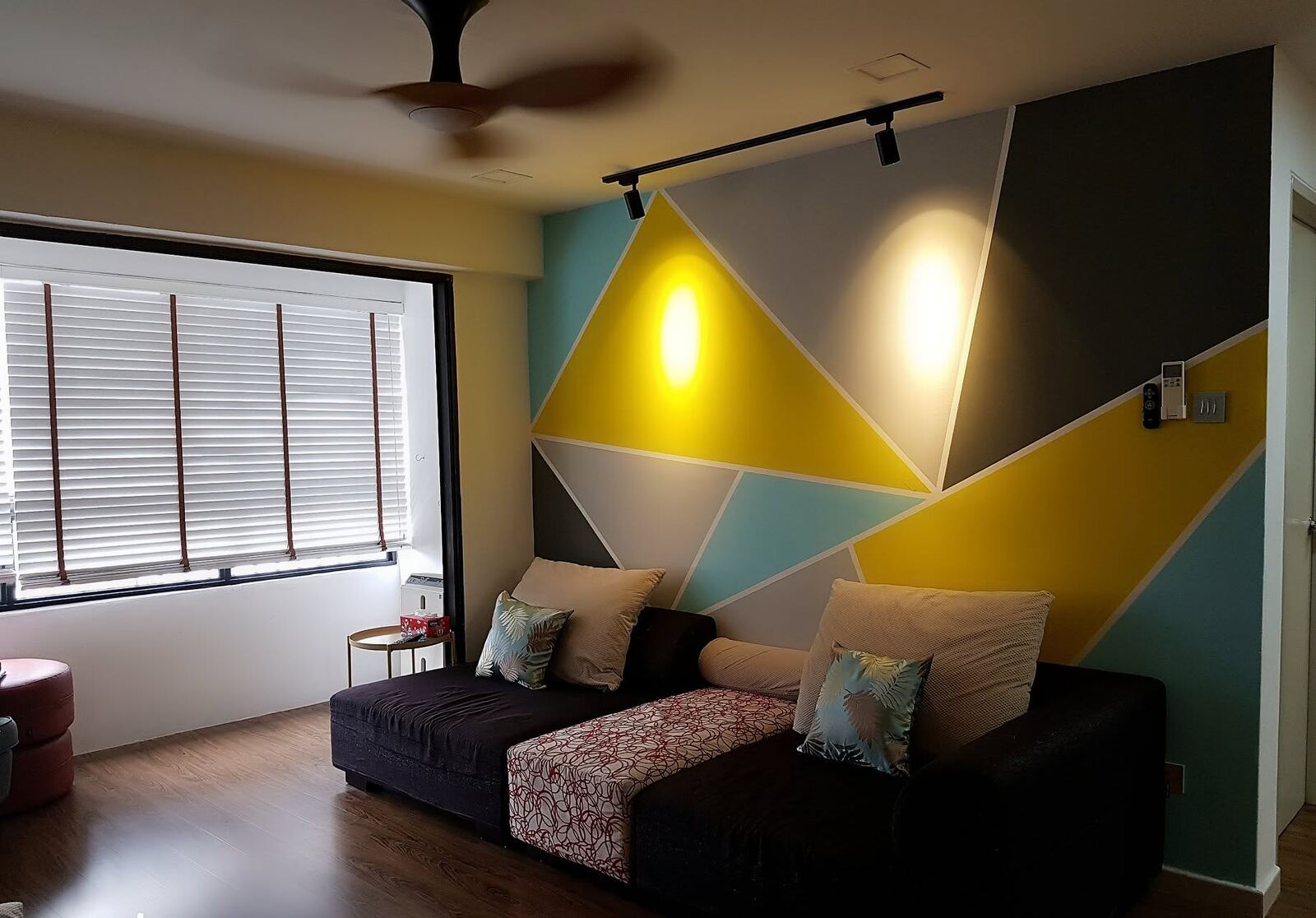 Living room with a geometric painted feature wall, renovated by Modern 9