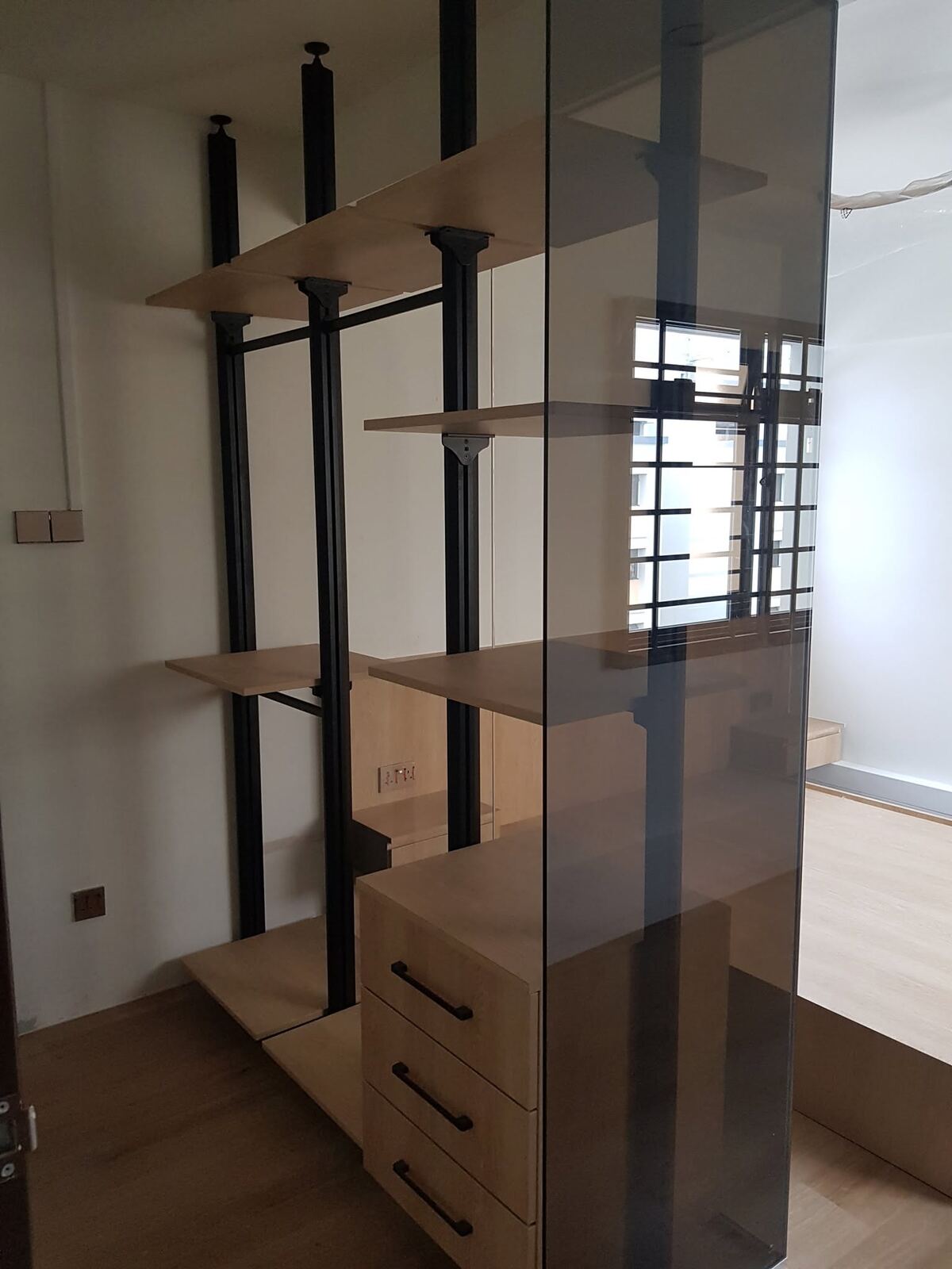 Black-frame shelf divider with oak drawers